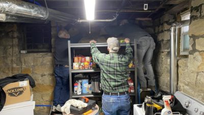 Jim Nudi, Dale Moore, and Bob Placke installing insulation